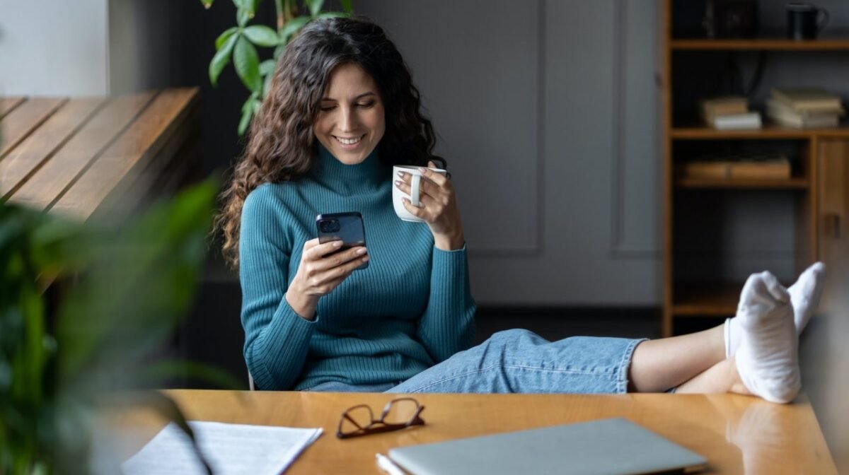 Remote worker girl procrastinate at workplace sit at desk with closed laptop chat in social media