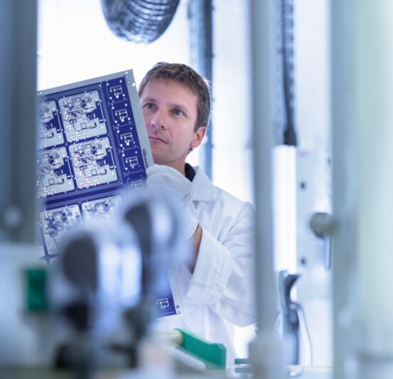 Worker inspecting circuit board by processing plant in circuit board factory Worker inspecting circuit board by processing plant in circuit board factory